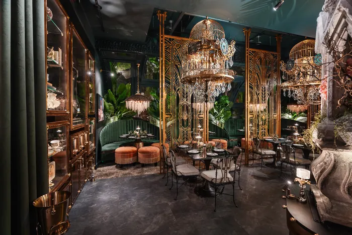 Wide view of the dining room with sculptural statuary and layered lighting