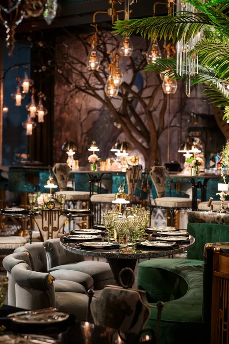 Lounge seating in grey and green velvet around low tables