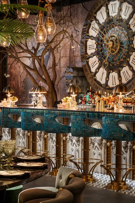 The bar's teal counter beneath the mosaic clock face